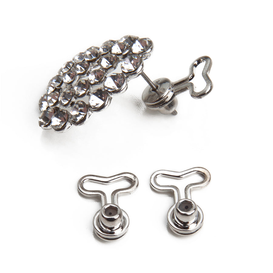 One pair of silvertone T-back T-shaped earring backs next to a silver gemstone-studded earring showing how the earring back fits onto a post earring.