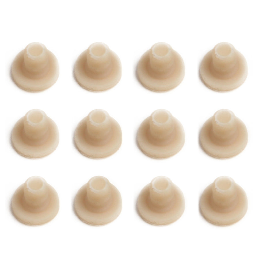 twelve evenly spaced beige rubber earring backs laid out in a square on a white background.