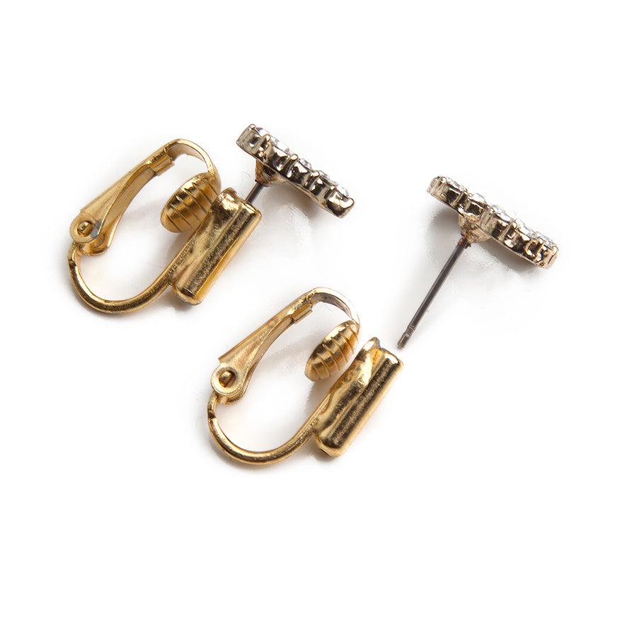 two post earring to clip on earring converters with a pair of gemstone heart earrings to show before and after using converters on a white background