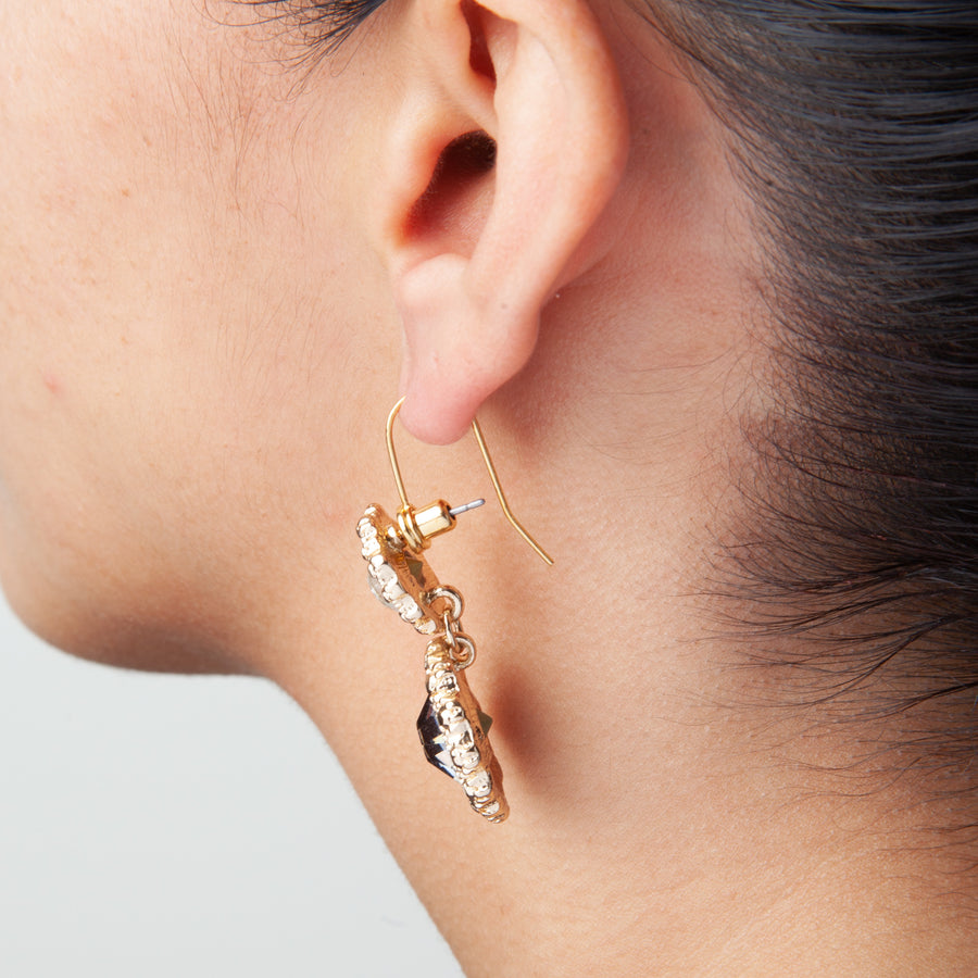 side view of an ear wearing Post to Wire earring converters with an earring in them to show how they look when worn.