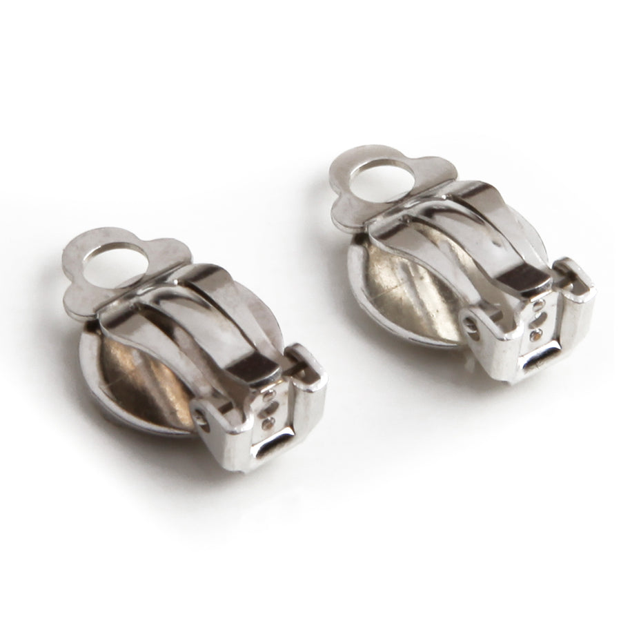 adhesive clip on earring backings to converter buttons or post earrings into clip on earrings with silvertone on a white background