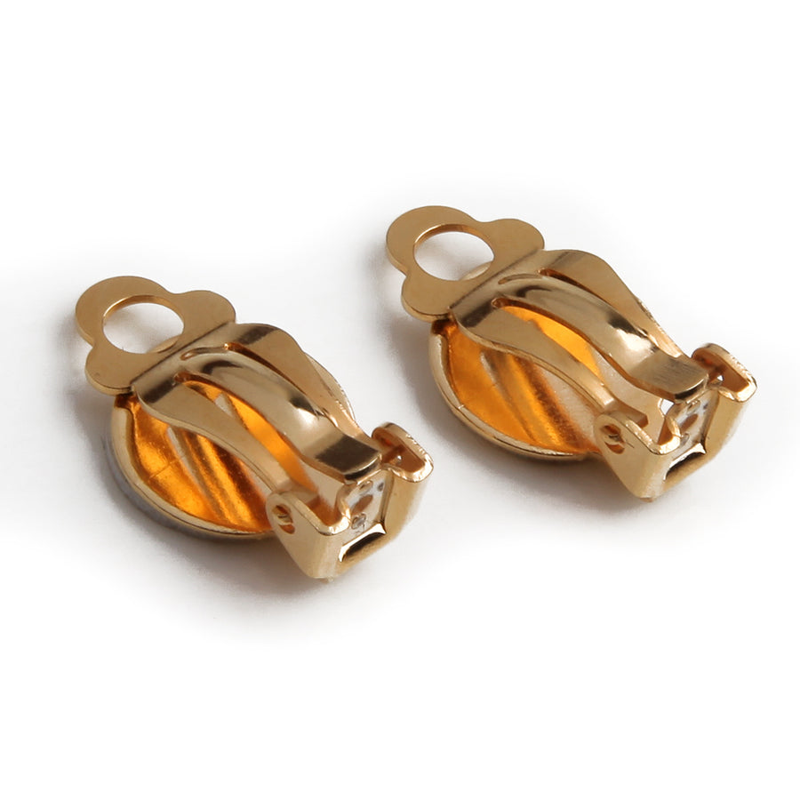 adhesive clip on earring backings to converter buttons or post earrings into clip on earrings with goldtone on a white background