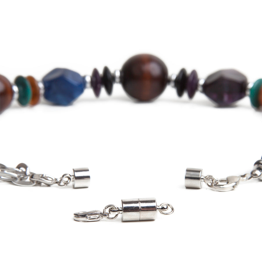 One silver large barrel magnetic necklace clasp in front of a large beaded necklace with attached silver large barrel magnetic clasp.