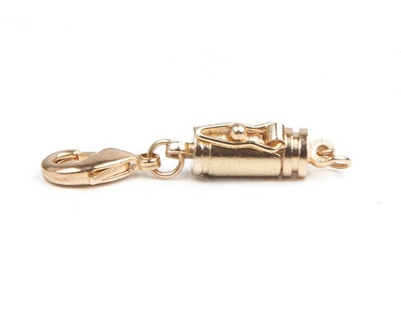 one goldtone small barrel magnetic clasp with a safety catch in the side.