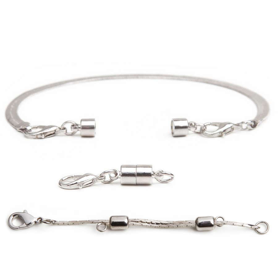 one silver adjustable necklace extender in front of one silver small barrel magnetic clasp with a silver bracelet with attached small silver magnetic clasp in background.