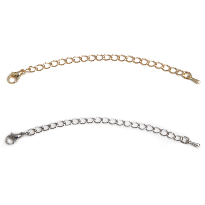 One gold necklace extender laid out next to one silver necklace extender.