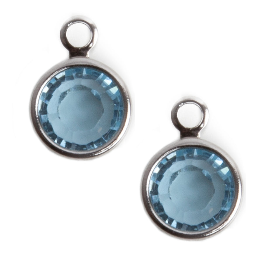 aquamarine crystal charms in a stainless steel setting with a look on top against a white background