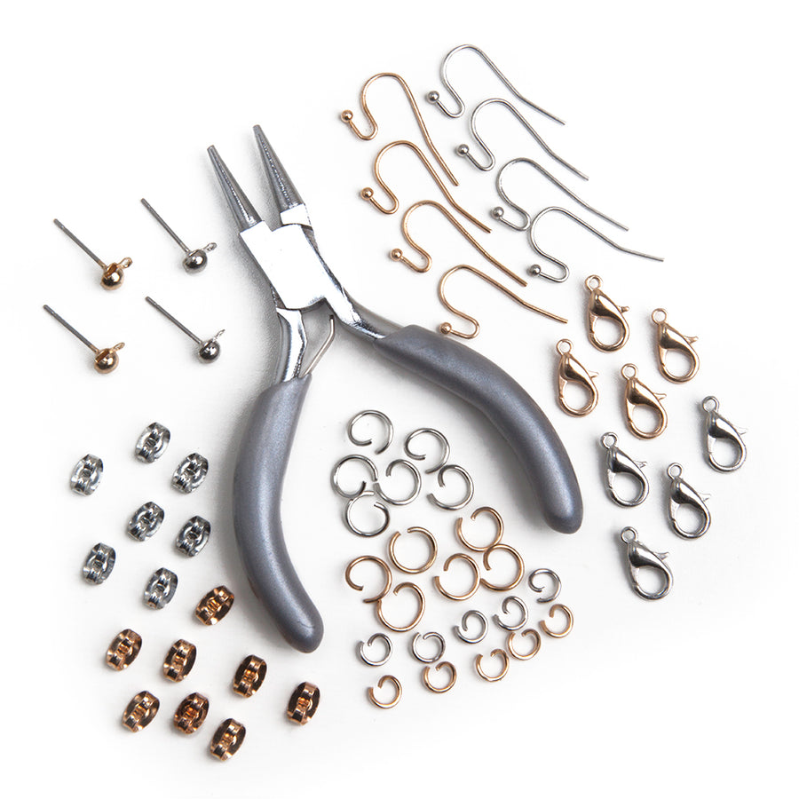Silver pliers surrounded by earring wires, jewelry lobster clasps. friction butterfly earring backs, small and large jewelry chain links, and dangle earring posts.