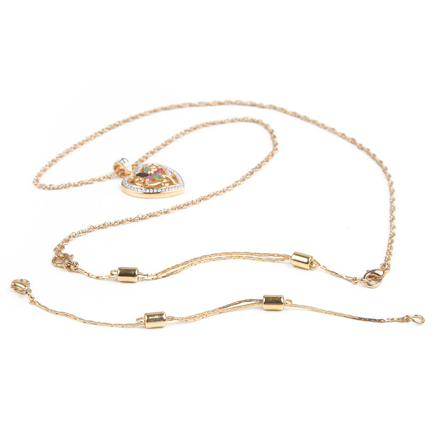 One gold adjustable necklace extender laid out in front of a gold heart necklace with attached gold adjustable necklace extender.