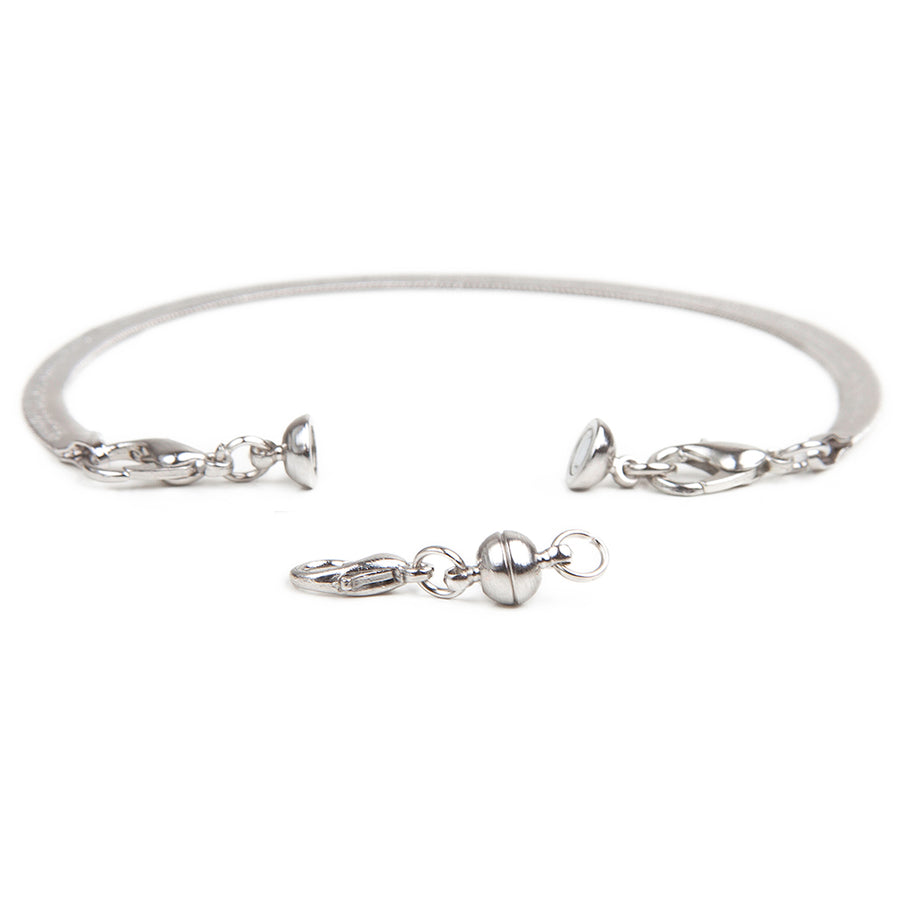 small silver sphere magnetic clasp in from of a silver bracelet with attached small silver sphere magnetic clasp.
