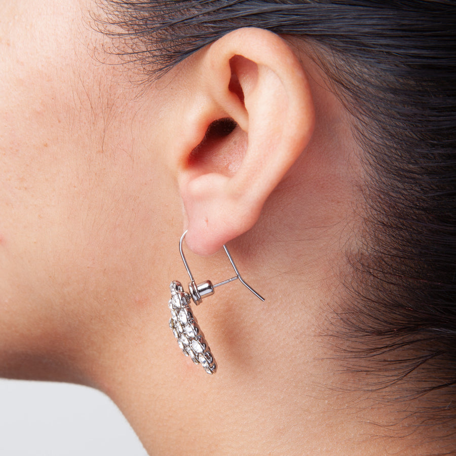 Side view of Post to Wire Earring Converter attached to a silver gemstone-studded earring to show how converter looks when worn.