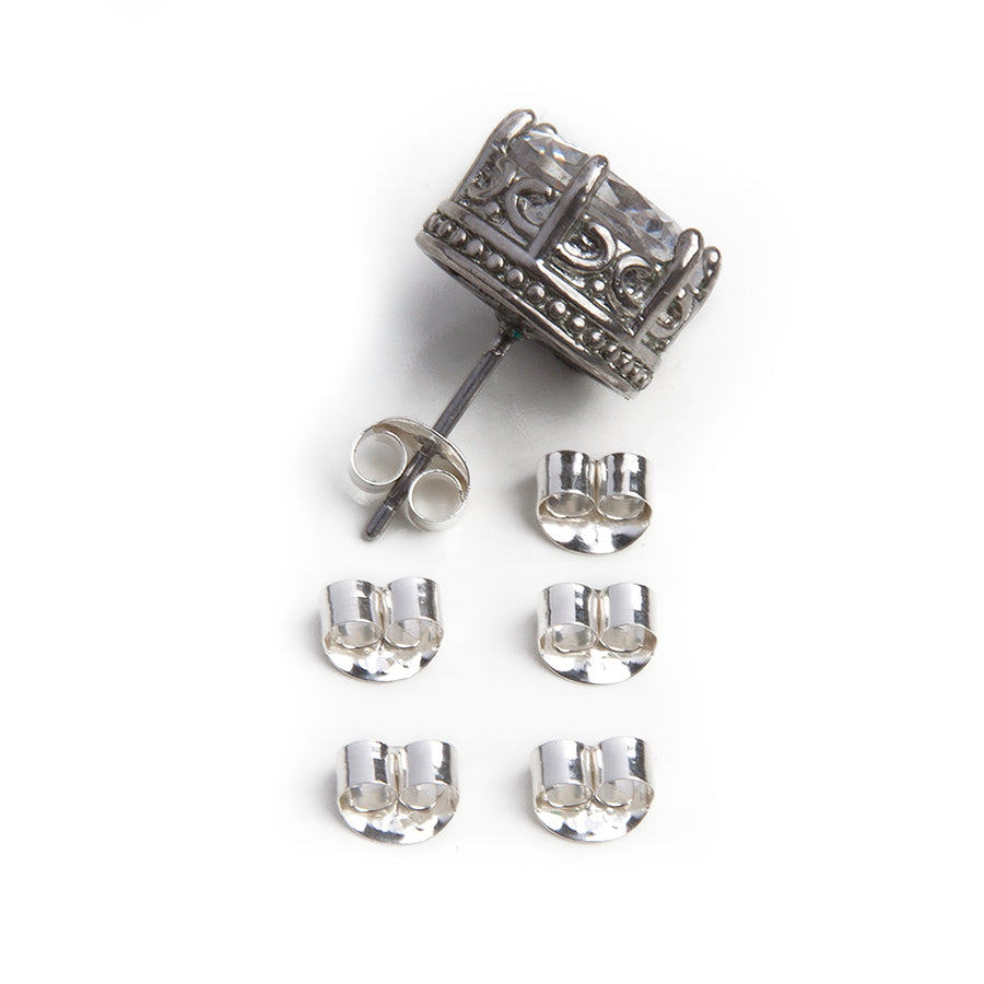 six butterfly friction earring backs made of sterling silver with a large earring with  intricate details along the side and a large clear stone at the front against a white background