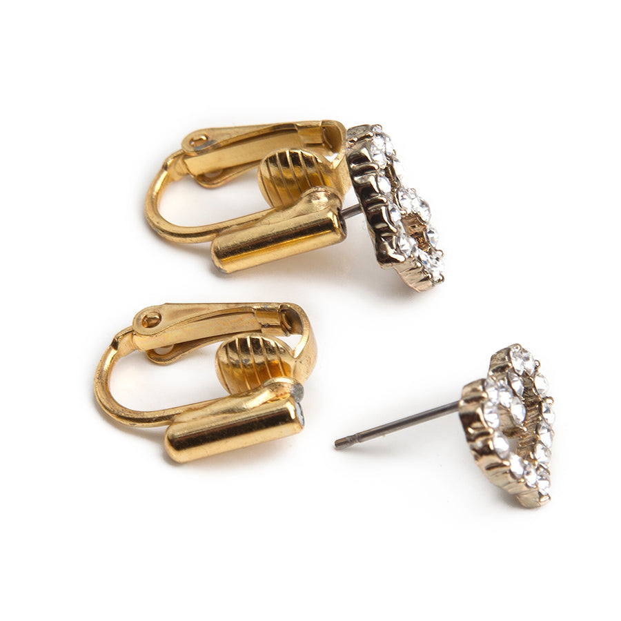 two post earring to clip on earring converters with a pair of gemstone heart earrings to show before and after using converters on a white background