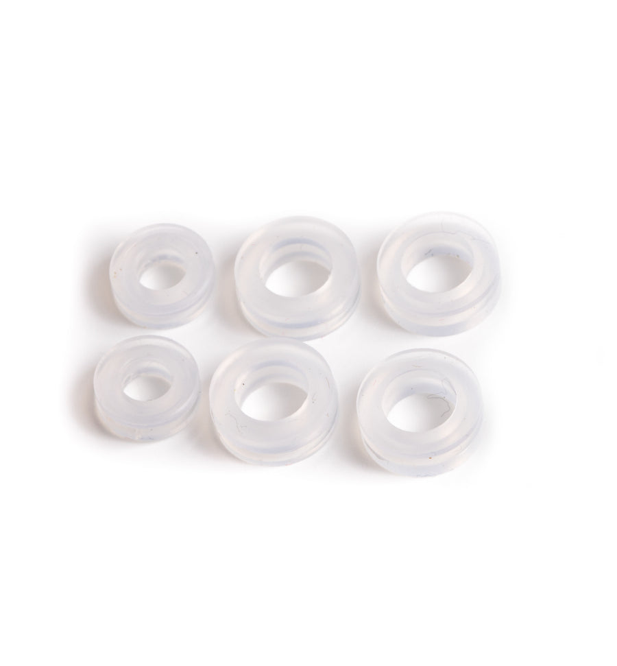 Three pairs of Clear Omega Clip Earring Cushions lined up on a white background.