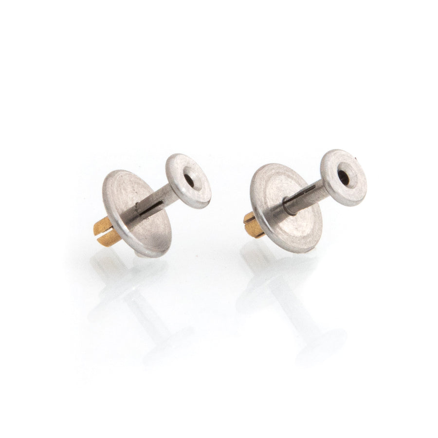 Metal earring sleeves called Lobe Lovers, on their side against a white background.